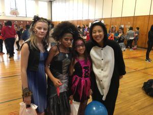 Lerner Fellow Eunice with three middle schoolers dressed up in costume