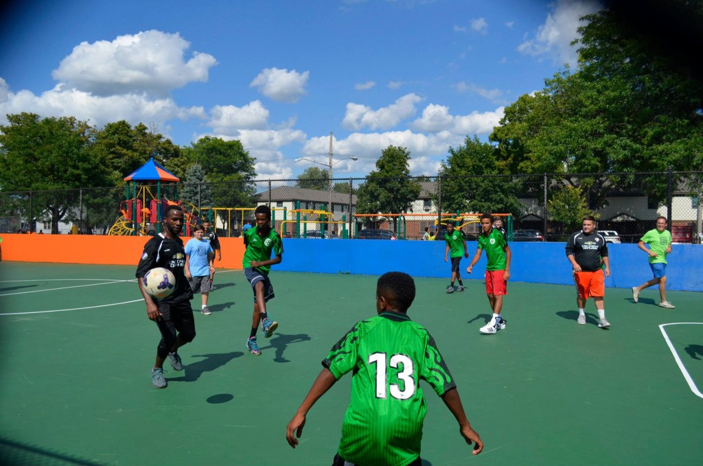 Kids playing soccer on newly renovated box soccer court at Skiddy Park.