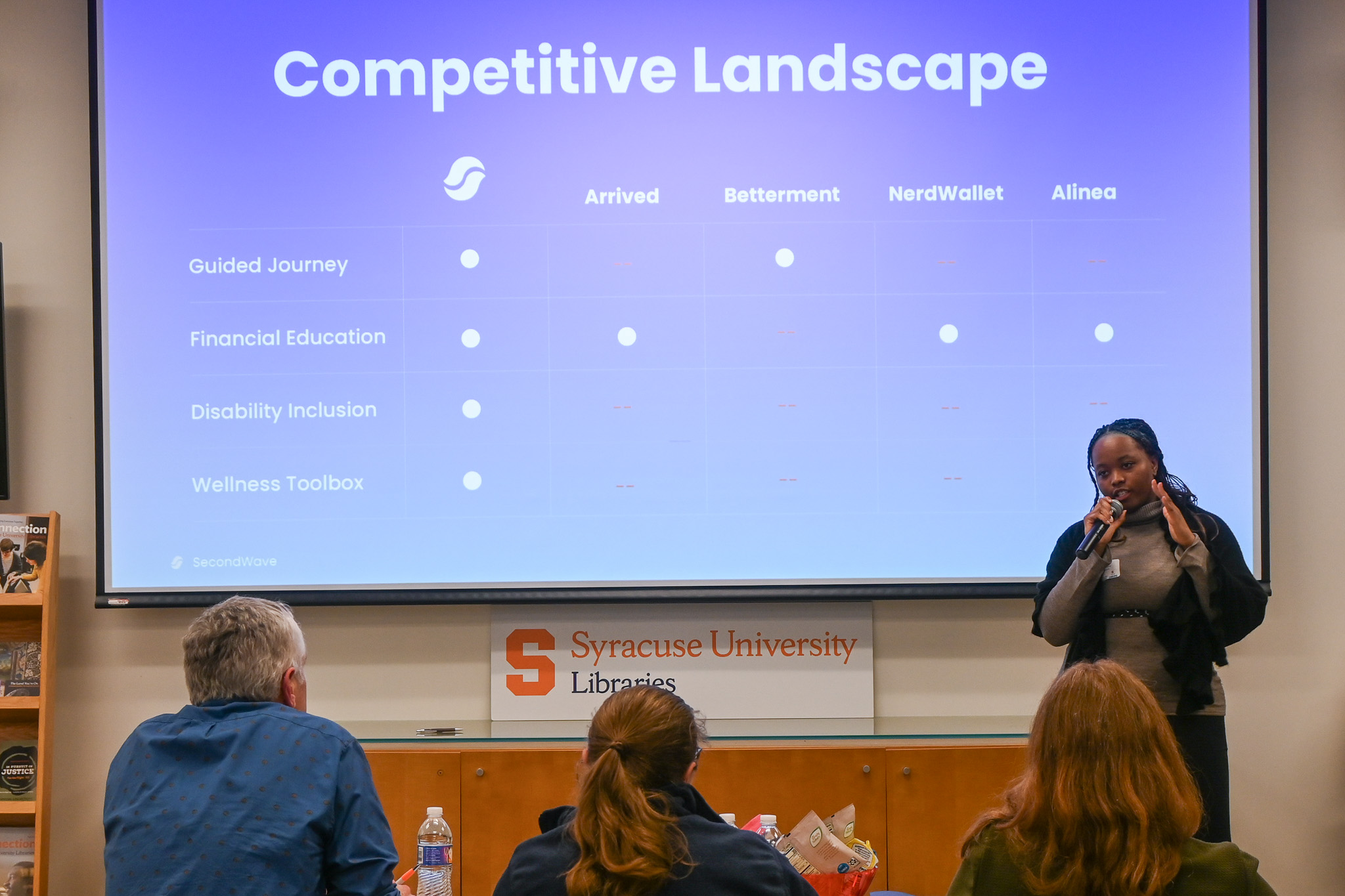 Student presents in front of a panel of three judges