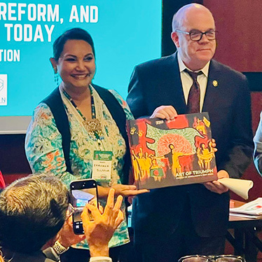 Two people holding a horizontal book