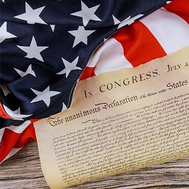Photo showing a portion of the US flag and the US Declaration of Independence
