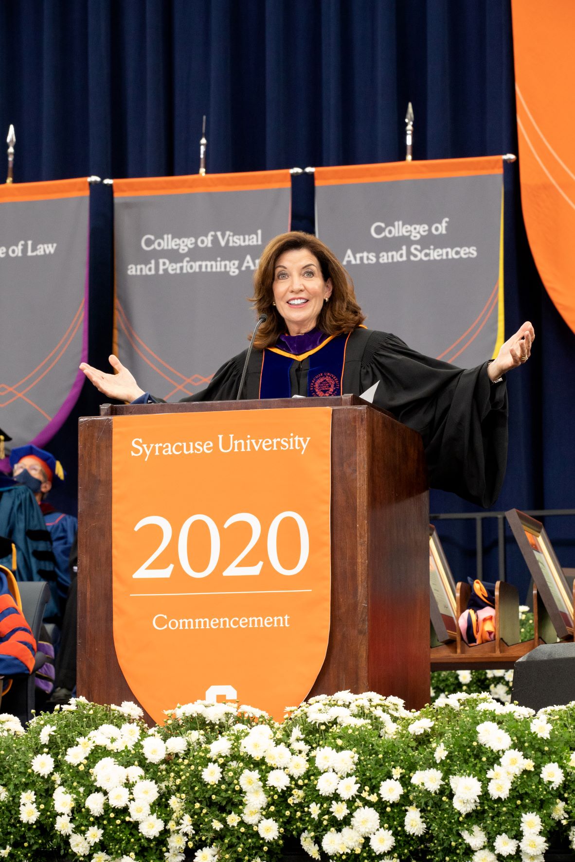 Woman at podium speaking during commencement ceremony