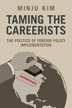 Cover of the book titled "Taming the Careerists: The Politics of Foreign Policy Implementation" by Minju Kim. It features an illustration of a hand stamping the word "Approved" on a globe.