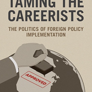Cover of the book titled "Taming the Careerists: The Politics of Foreign Policy Implementation" by Minju Kim. It features an illustration of a hand stamping the word "Approved" on a globe.