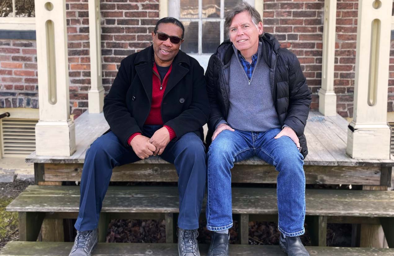 Reverand Paul Carter and Professor Doug Armstrong on the steps of the Harriet Tubman House