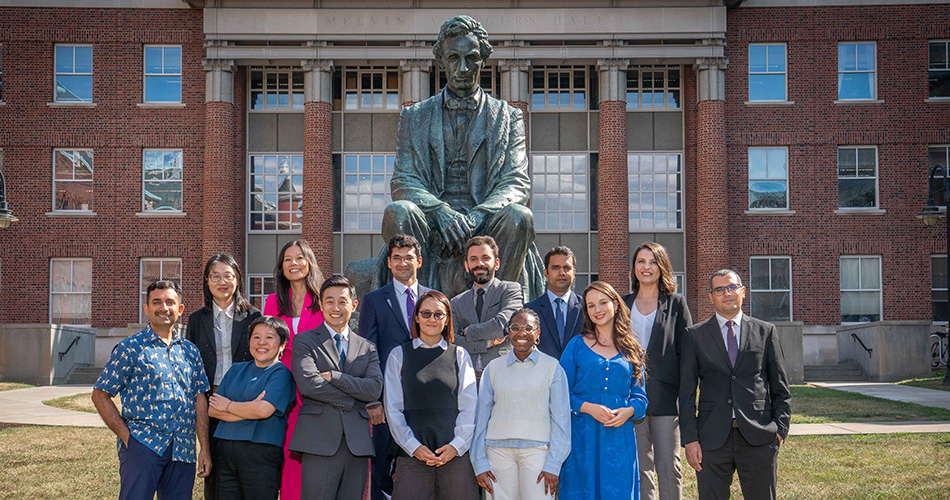Humphrey Fellows group poses by the Lincoln statue outside Maxwell Hall.