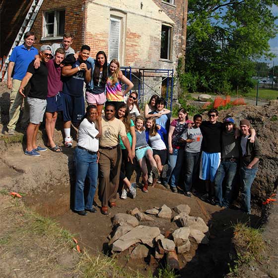 Anthropology faculty and students doing a dig