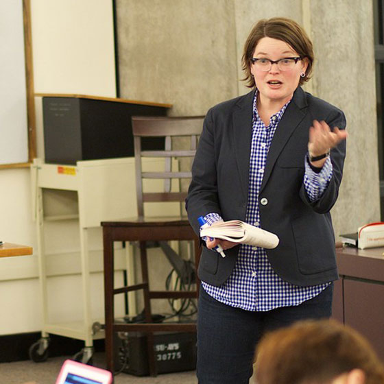 Professor Purser teaching in front of a classroom