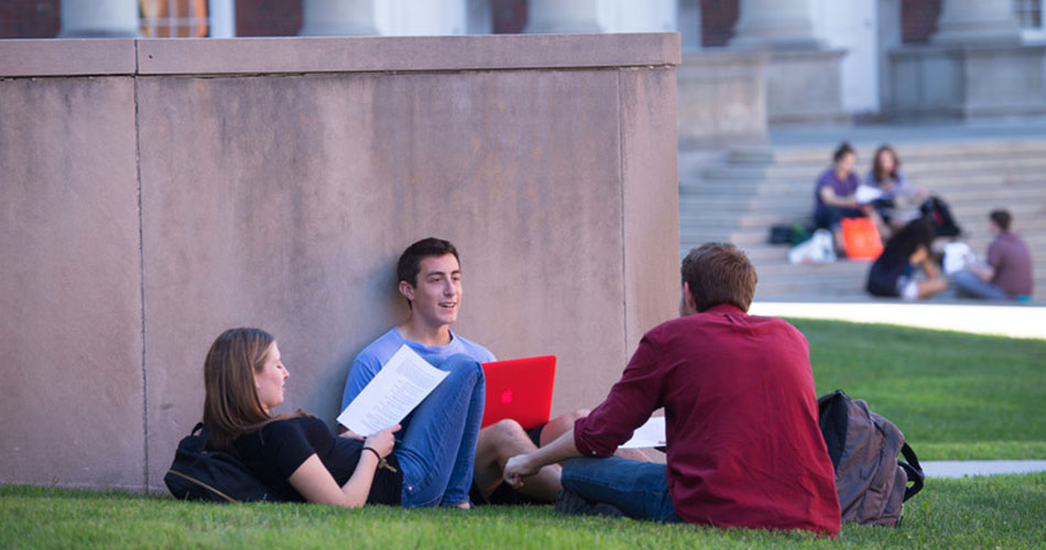 Students sitting on the lawn outside of Eggers Hall