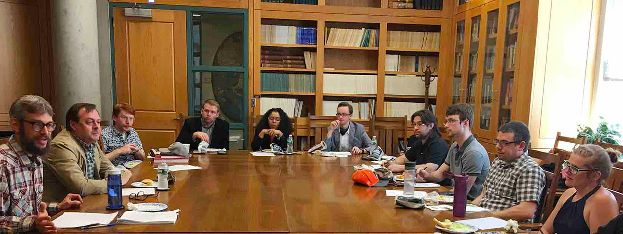 Group of faculty and students in history conference room