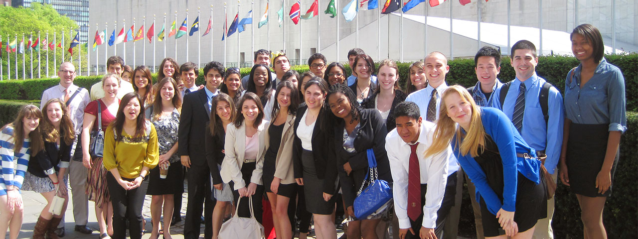 Group of students in front of flags at the UN