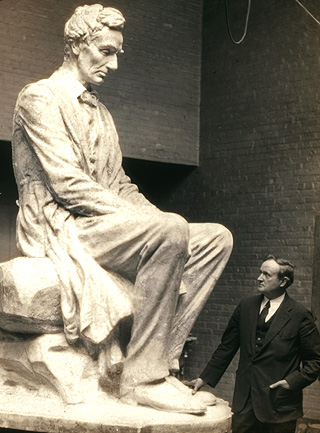 Old photo of man standing by Abe Lincoln statue
