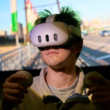 Person using a virtual reality headset and handheld controllers