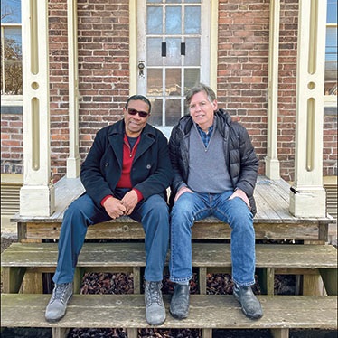Two men sitting on a porch