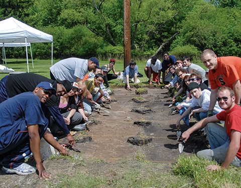 Students surround a dig site at the Harriet Tubman Home in Auburn, NY