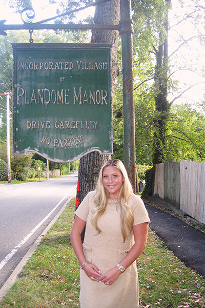 A person smiling, standing in front of the