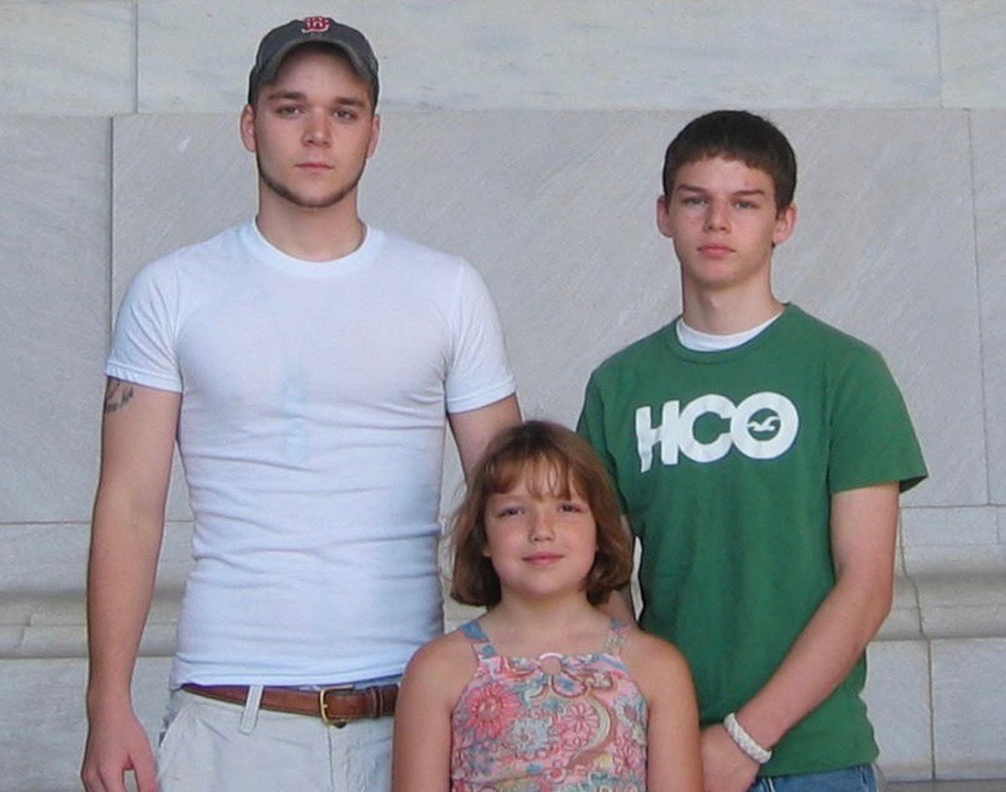 Three young people are posed together