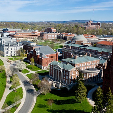 Aerial view of the Syracuse University campus featuring historic buildings and lush greenery.
