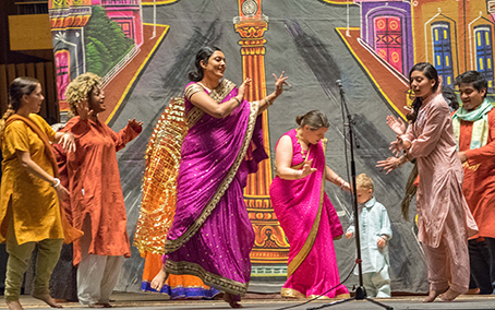 Students in colorful saris performing an Indian folk opera in memory of Agehananda Bharati