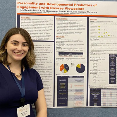 Madison stands beside a research poster