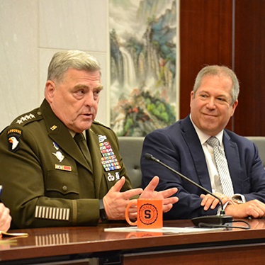 Army General Mark Milley talking while seated next to Mark Jacobson