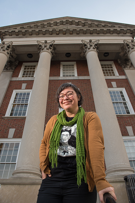 Fabiola Ortiz Valdez stands on the steps of Maxwell Hall wearing a Frida Kahlo t-shirt