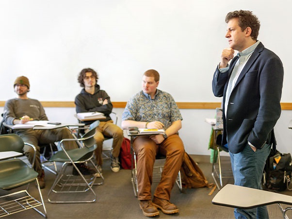 A professor speaking to a class of students